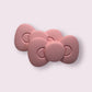 Set of two pink silicone hair clips with a cute bow design, perfect for stylish hair accessories.