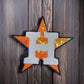 Sparkly star decoration featuring orange and silver sequins with an 'H' logo, perfect for festive decor.