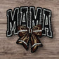 Embroidered patch with 'MAMA' in black and a brown bow, perfect for customizing bags or clothing.