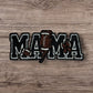 Embroidered patch featuring 'MAMA' in bold letters with football and baseball graphics, black and brown colors.