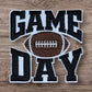 Embroidered patch featuring 'GAME DAY' text and a football, perfect for sports enthusiasts.