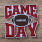 Red and white embroidered patch featuring 'GAME DAY' and a football, perfect for sports fans.