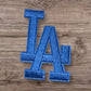 Blue embroidered LA patch, ideal for jackets and hats, featuring a stylish design and durable material.